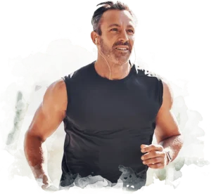 Fit middle-aged man in black muscle shirt running – illustrating benefits of testosterone therapy at Infinite You Wellness Clinic in Garden City, NY.